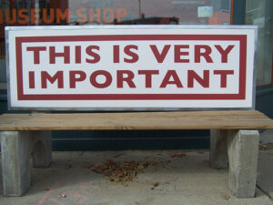 "This Is Very Important" is painted on a bench.