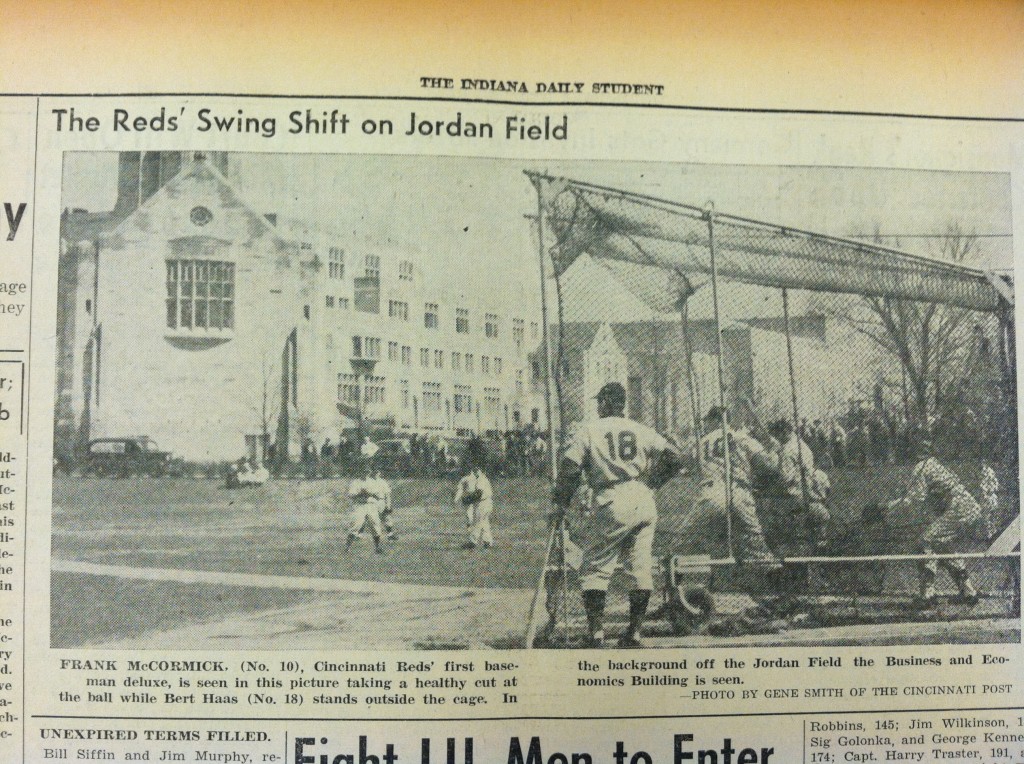  Scanned image of a newspaper page with a photograph of a baseball game and the headline "The Reds' Swing Shift on Jordan Field."