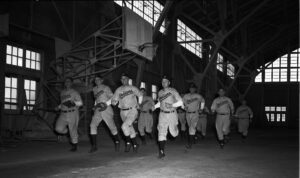  Black and white photograph of baseball players running. 