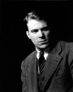  Black and white photograph of a man in a suit. 
