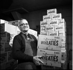 IU employee with boxes of Wheaties cereal, December 10, 1964