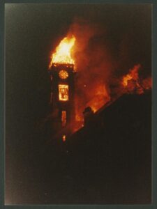 The Student Building's clock and bell tower ablaze on Dec. 17, 1990.