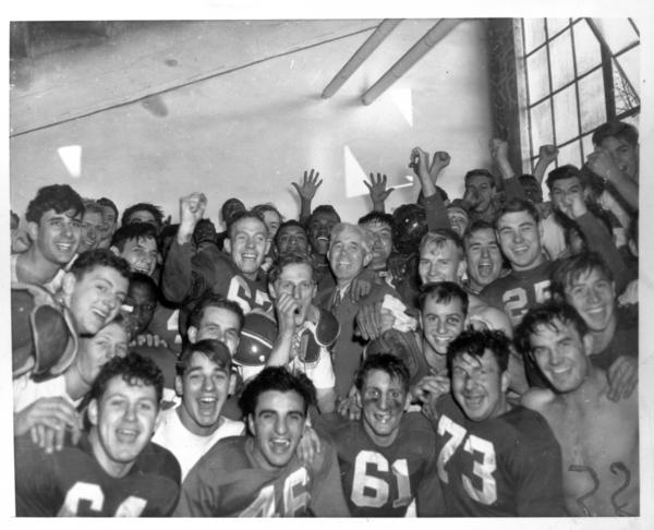 1945 football team in locker room after beating Purdue