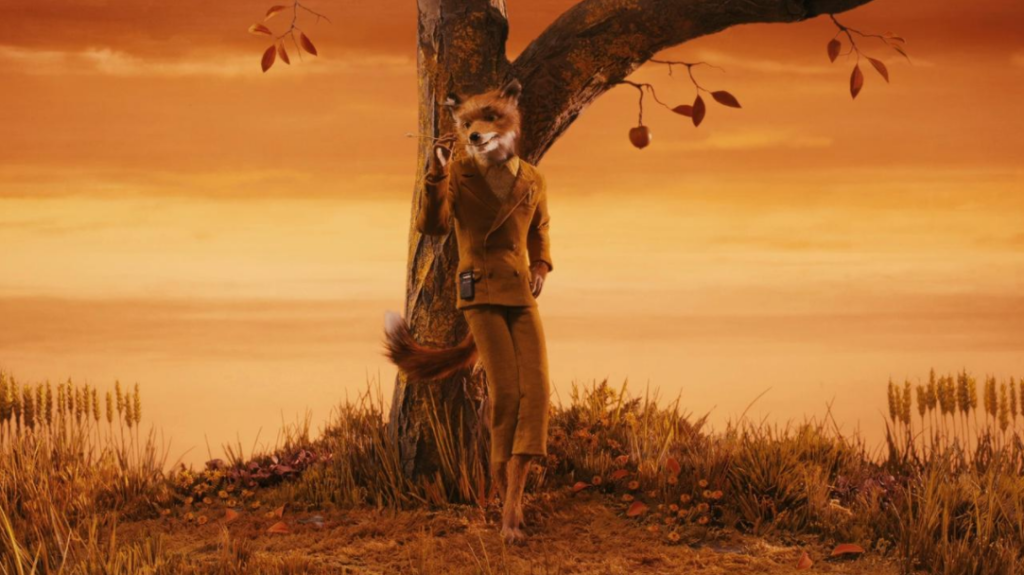 Image from the film Fantastic Mr. Fox showing Fox standing by a tree at sunset.