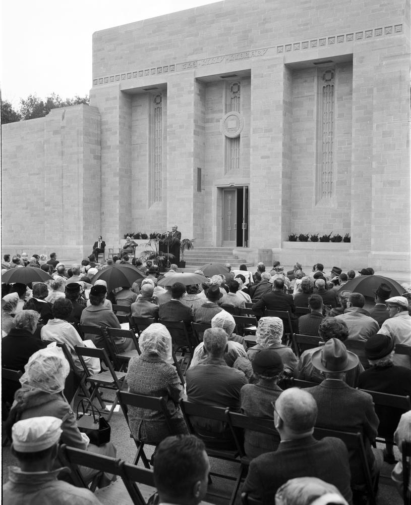 Black and white image of a crowd sitting in front of Lilly Library during the dedication ceremony. 