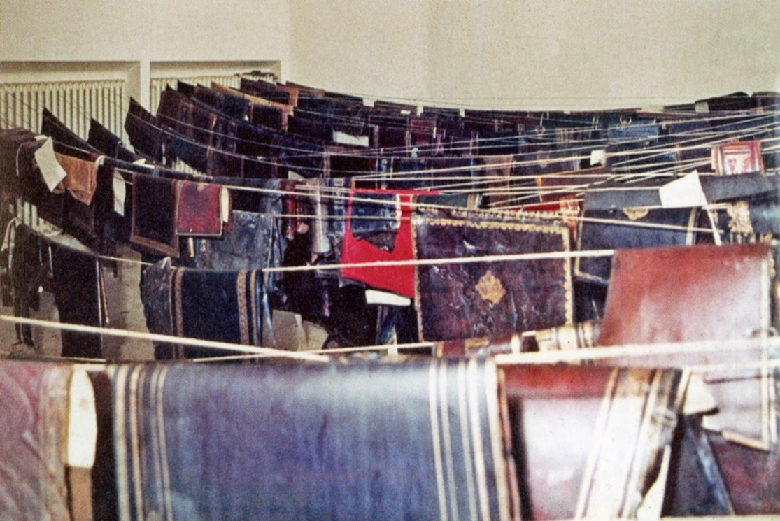 Color photograph of textiles being dried on clotheslines.