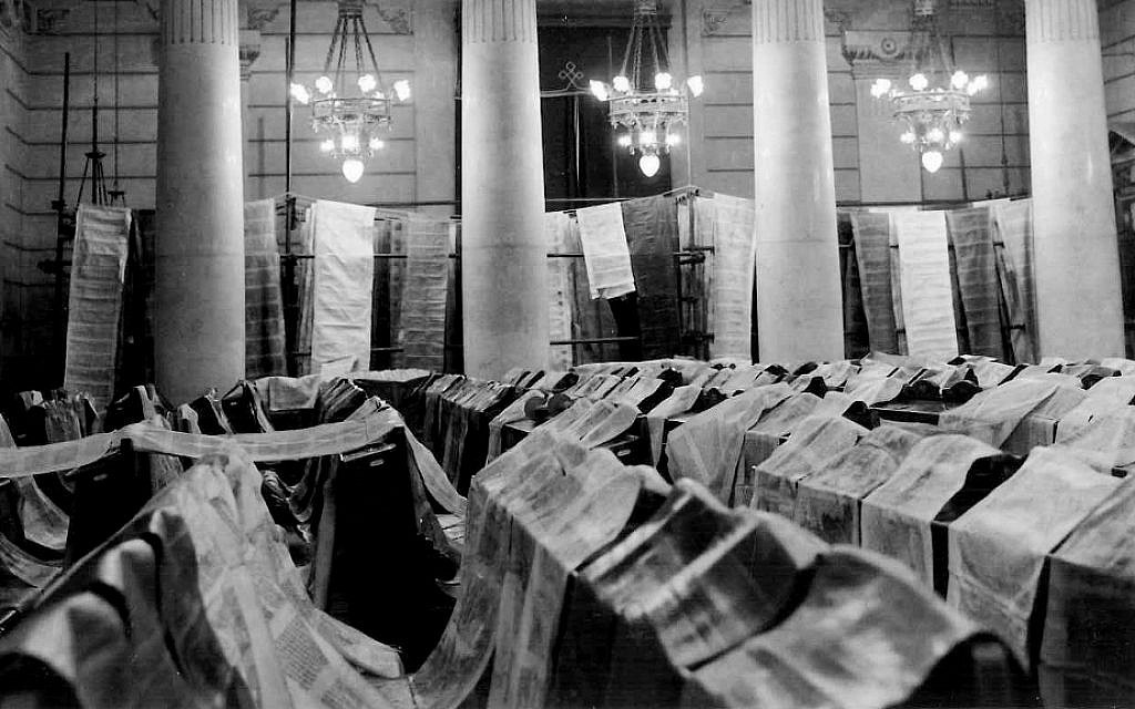 Black and white photograph of scrolls spread across chairs.
