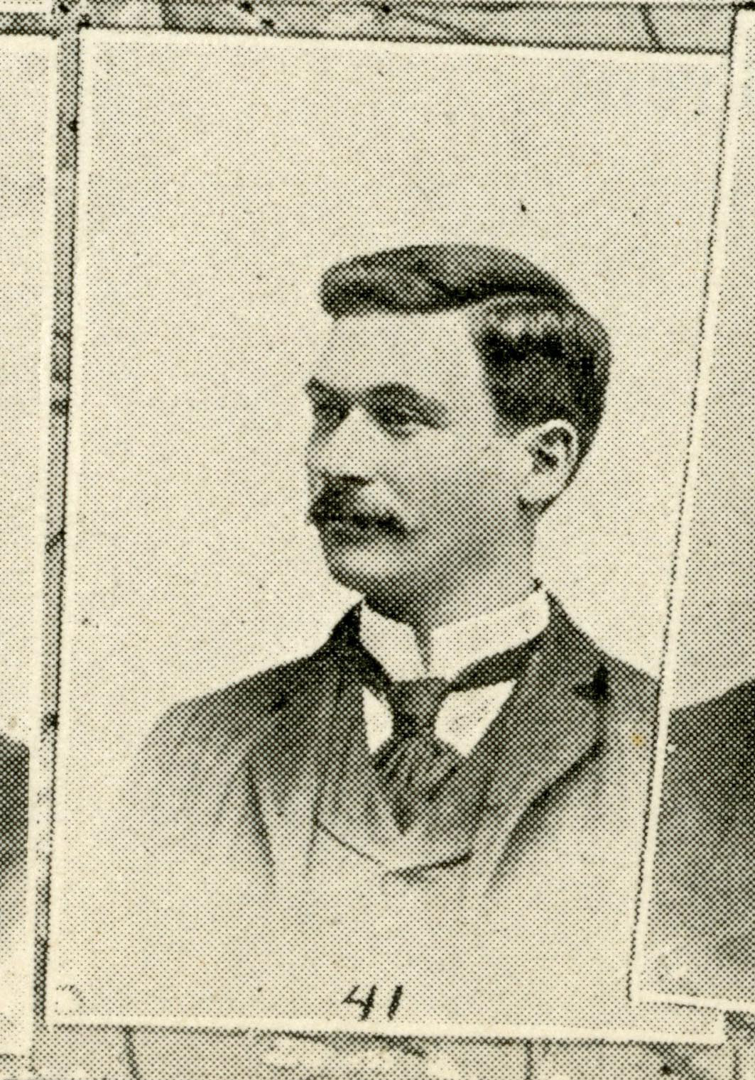 Black and white scan from the IU Arbutus yearbook. Image shows a man with dark hair and mustache wearing a suit and tie. 