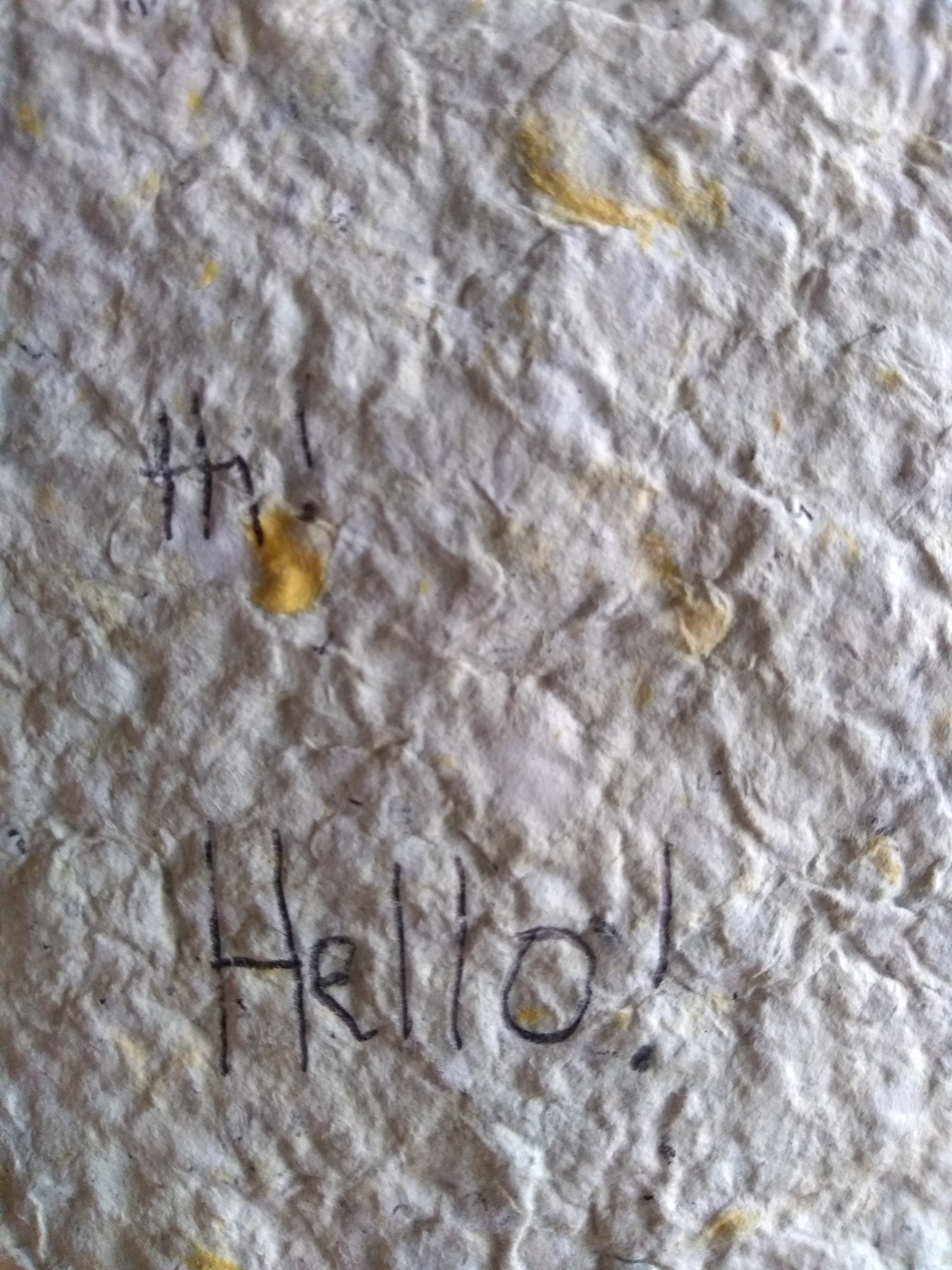 Handmade paper with the word "Hi!" written on it.