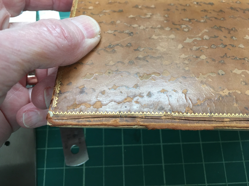 Front cover showing the beveled cut first made in the leather.