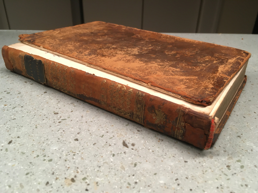 A leather-bound book with detached front cover.