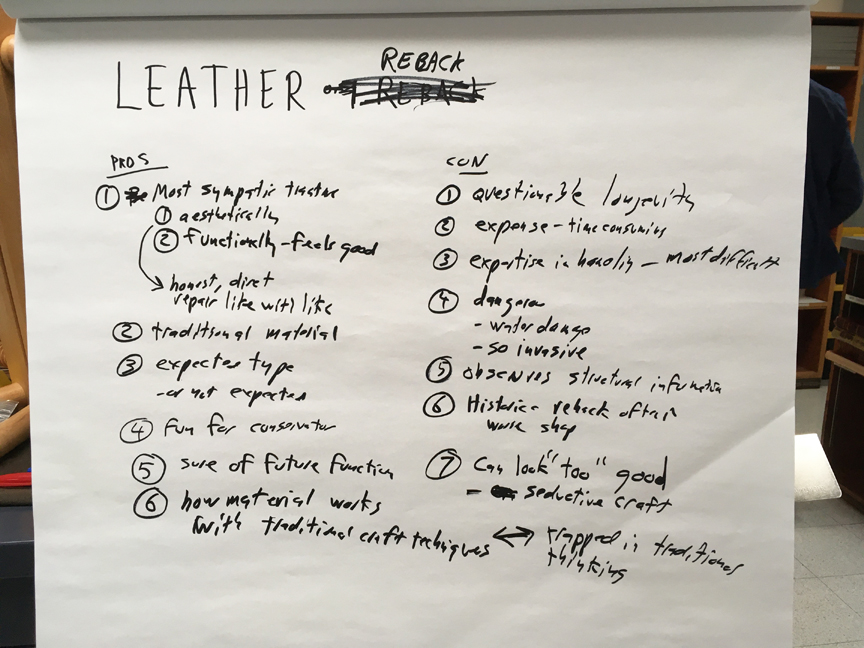 List of pros and cons of leather rebacking written on a large white pad of paper