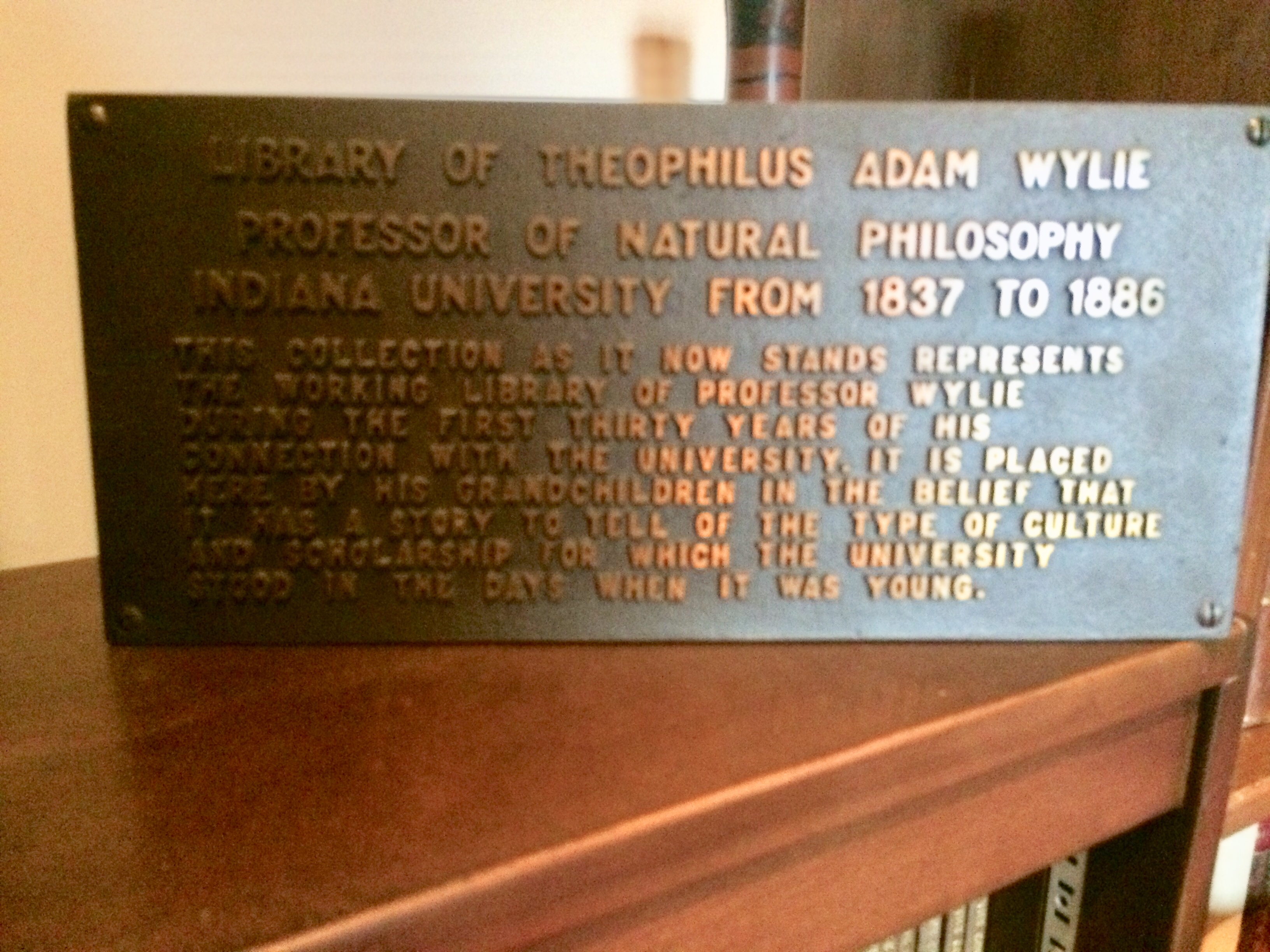 plaque stating "library of Theophilus Adam Wylie Professor of Natural Philosophy Indiana University from 1837 to 1886