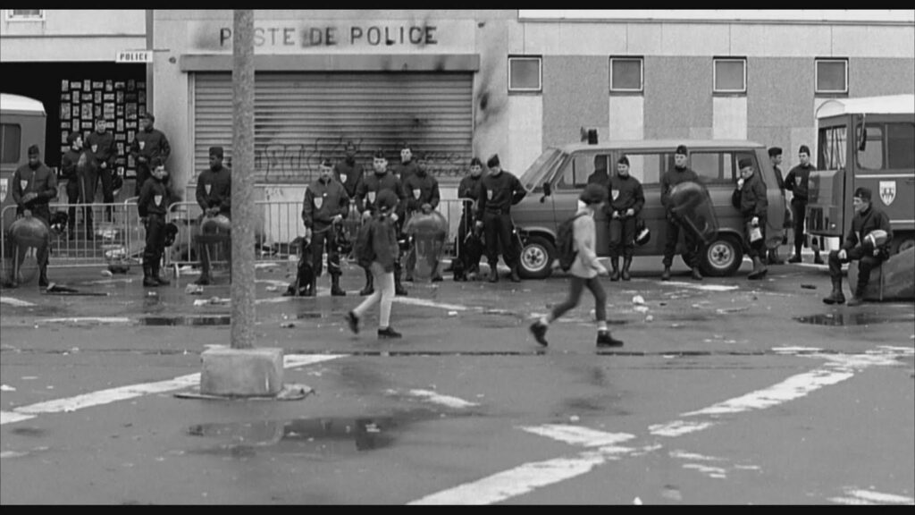 Still image of police and children from the French movie, La Haine