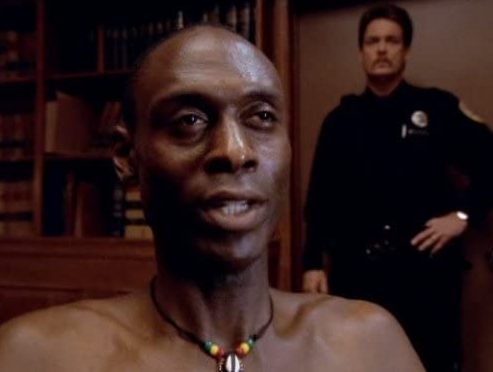Promotion image of a black man and guard from the TV series, Oz.