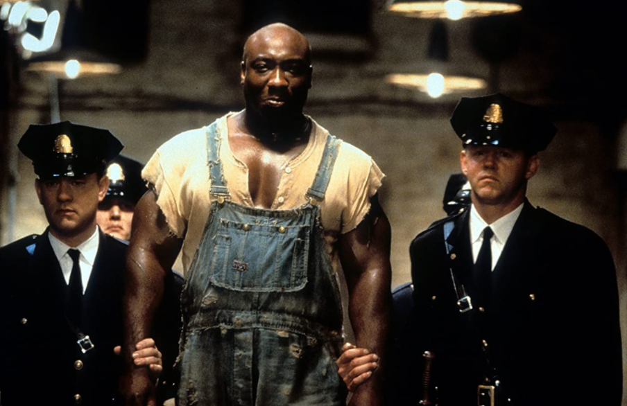Promotional photo of three visible prison guards and one prisoner from the movie The Green Mile