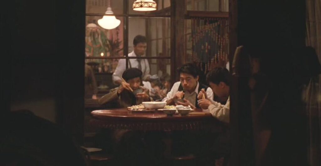 still image from the movie, A City of Sadness, four men in a restuarant
