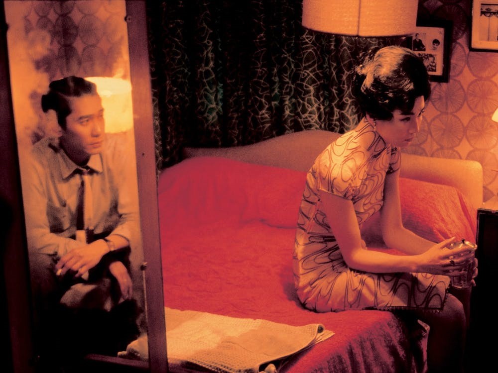 Still image of a man and woman in a bedroom from the movie, In The Mood for Love
