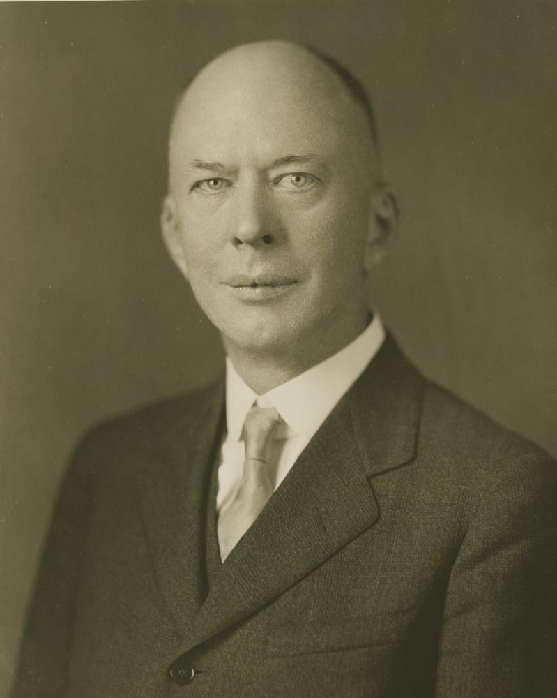 Black and white photograph of a man in a suit. 