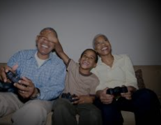 A family of three holds gaming controllers