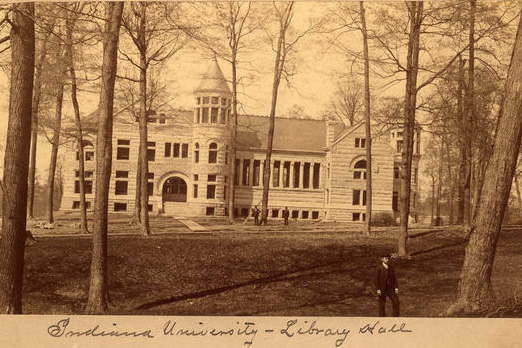 Sepia tone photograph of Maxwell Hall through the trees of Dunn's Woods