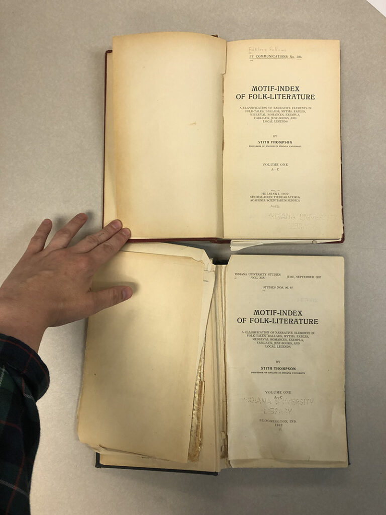 Two copies of the same book, with damaged and detached pages