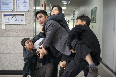 Men and children entangled in a promotional photo from the movie Extreme job