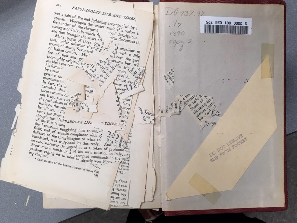 A book with brittle paper, with the pages broken into small bits