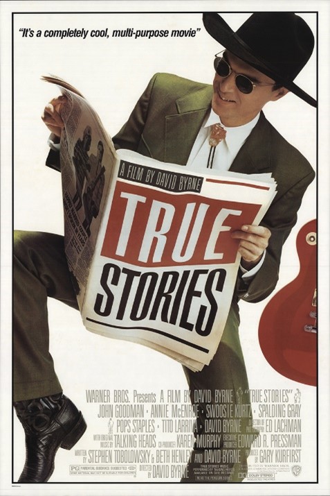 DVD cover art for the film "True Stories." A man in a green Western-style suit, bolo tie, black cowboy boots and cowboy hat reads a newspaper, the front page of which says "True Stories" in large, bold print.