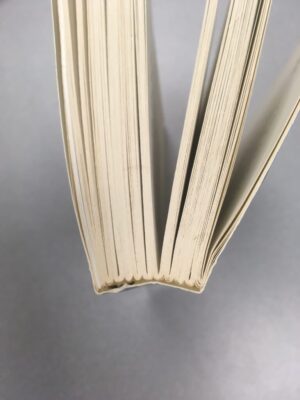 View of a book looking down at the top edge, showing the scalloped edge indicating the book is in signature form.