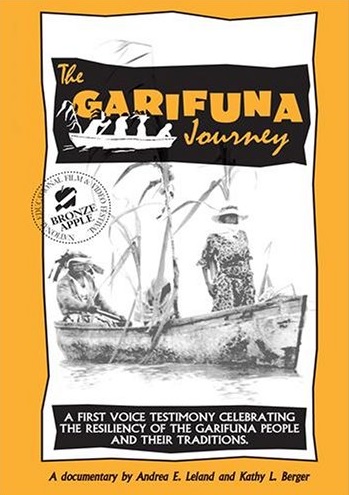 Film title, "The Garifuna Journey," appears at top in golden yellow with a black background. Underneath is a black and white depiction of two people in a small wooden boat on the water, one standing in the bow and one seated in the stern Both are dressed in sun hats with full-length clothing.