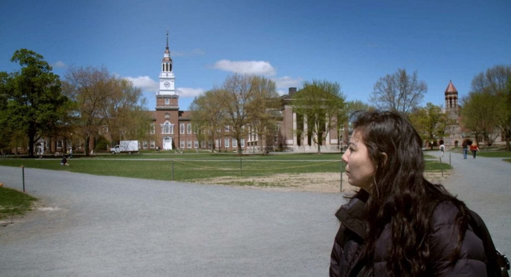 Image of filmmaker Melissa Padilla outdoors on a college campus. 