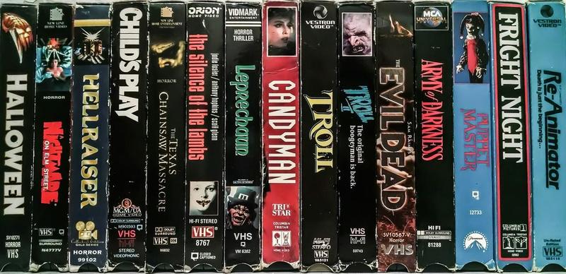 Photograph of several VHS cassette tapes lined up with their titles showing.