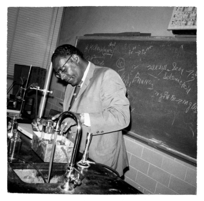 Black and white photograph of Ernest Stevenson in a classroom laboratory. 