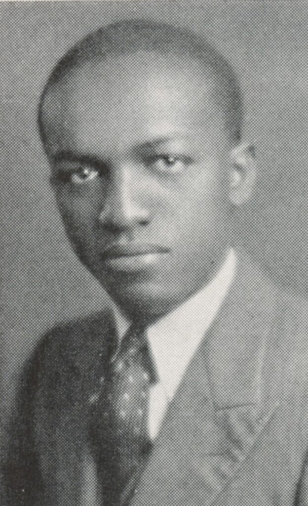 Black and white yearbook photo of George Wade wearing a suit and tie