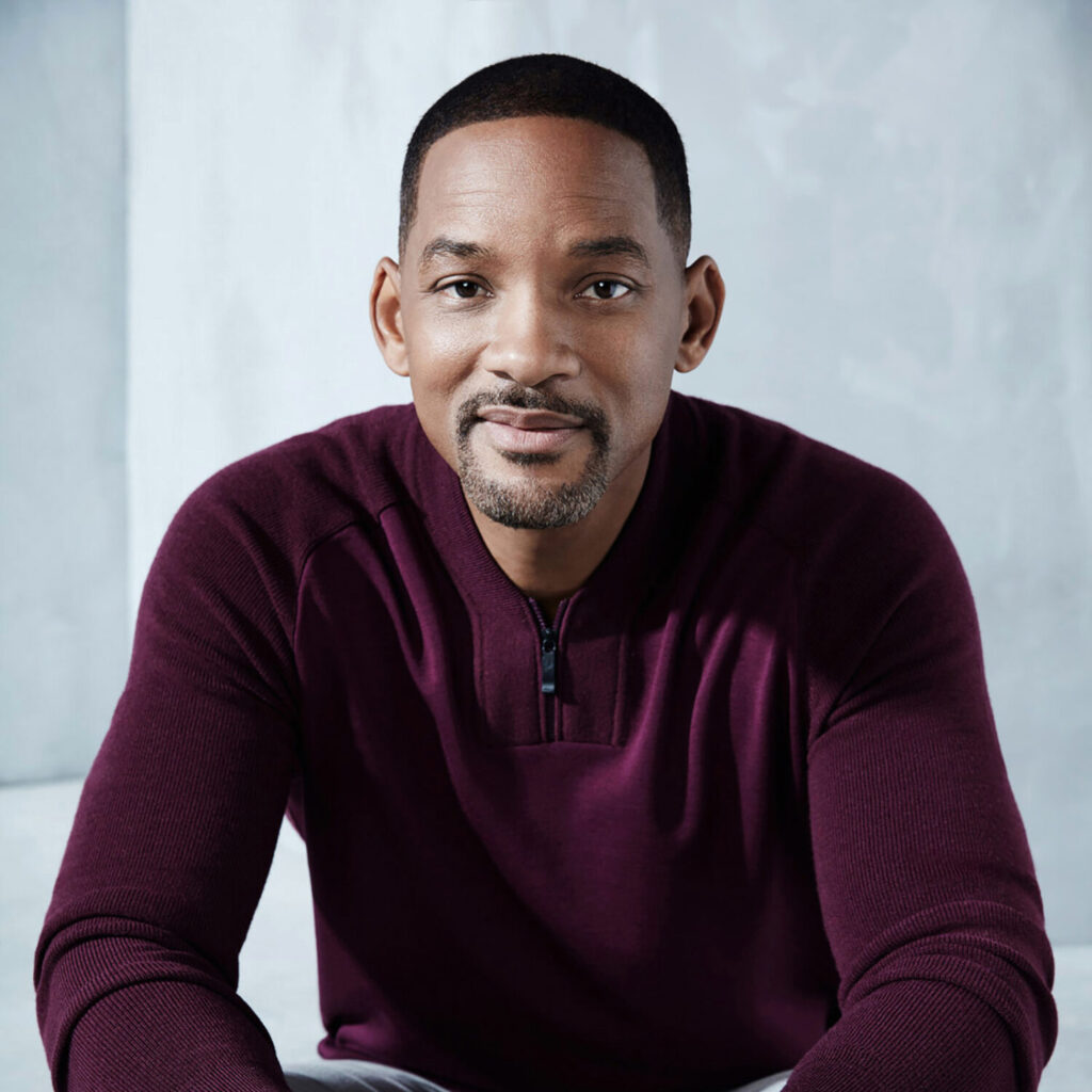 Headshot picture of Will Smith smiling at the camera.