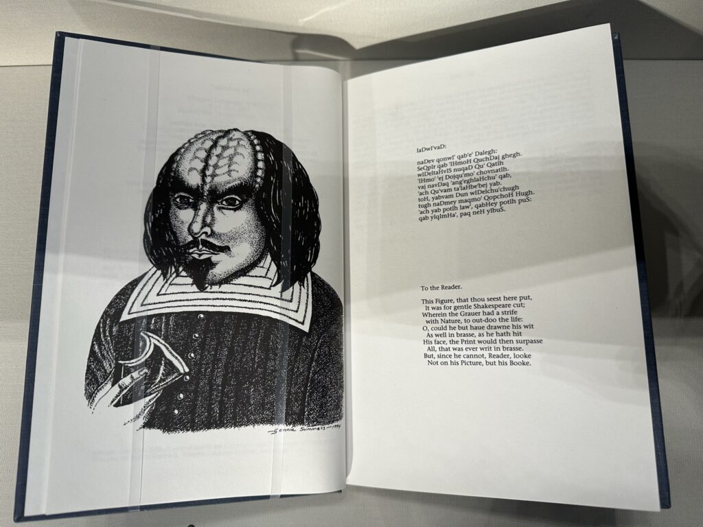 The Klingon Hamlet, open to the dedicatory page. The dedication is rendered in Klingon and English. Facing is a portrait of Shakespeare as a Klingon.