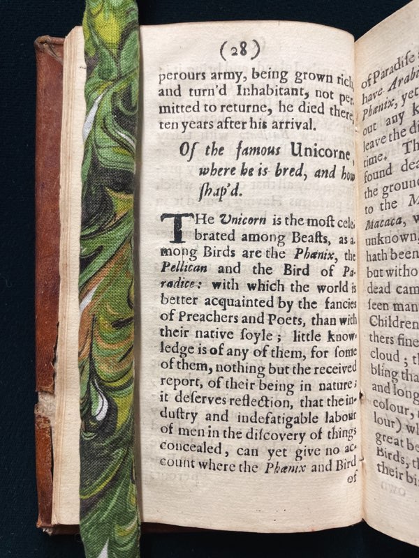 Book open to a page of description about unicorns