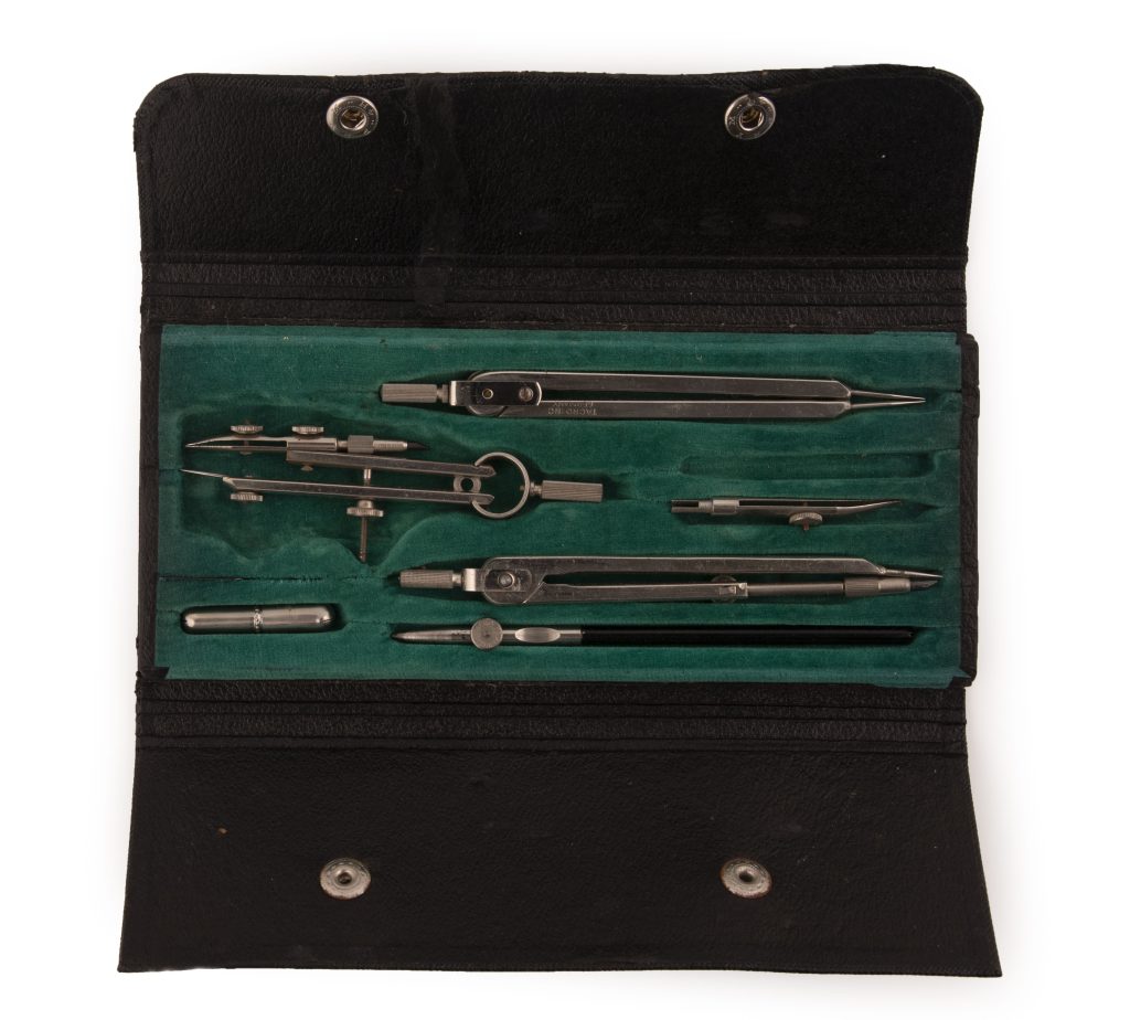 Open snap case with green felt lining, containing five metal tools used for drafting