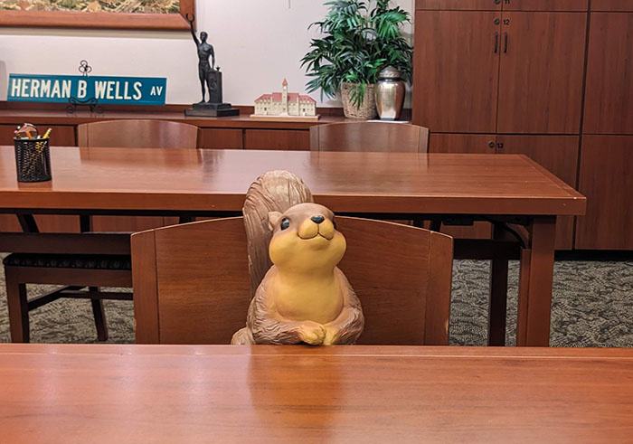 Image of the IU Archives reading room with a photoshopped squirrel at a table. 