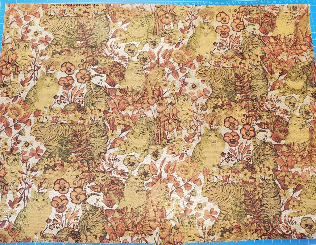 Decorative paper with red and orange florals, shiny golden cats, and a shiny silver background