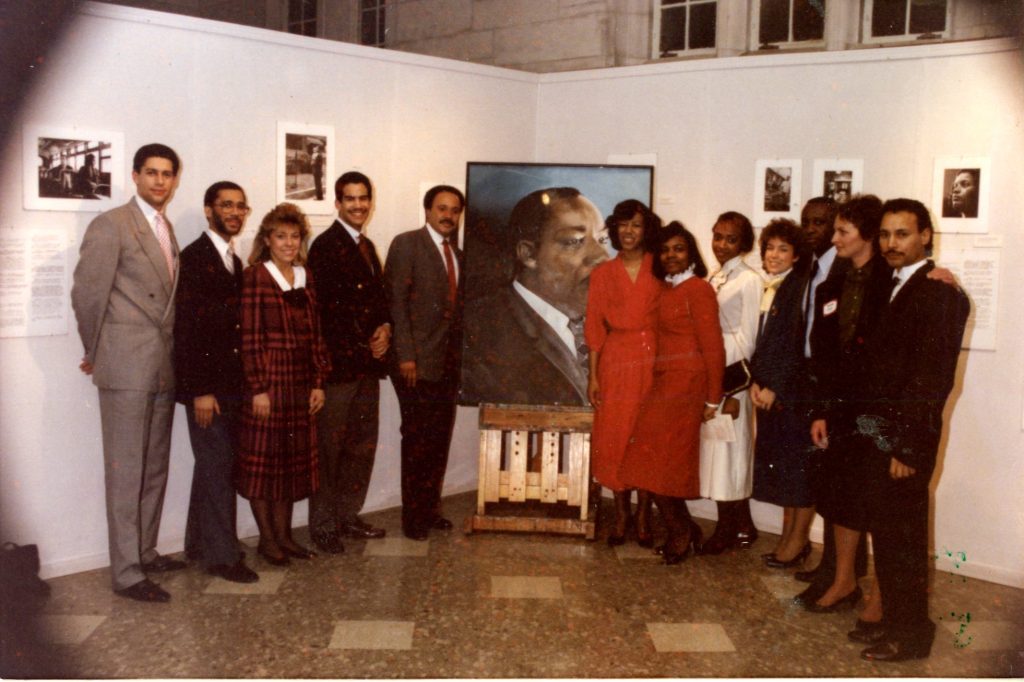 Group gathered around MLK portrait