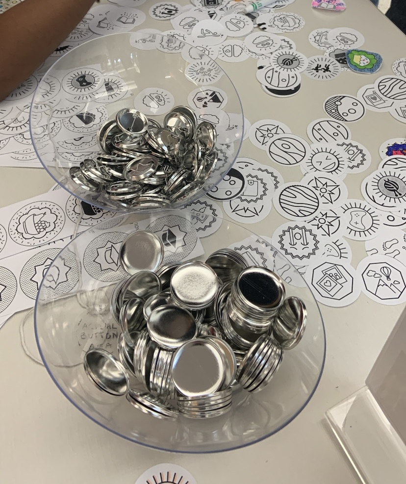 This is a photo of button making supplies and potential designs students could use